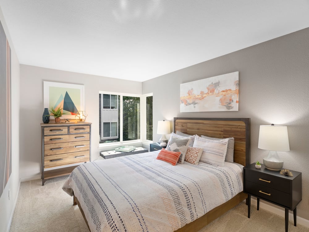 Well-furnished master bedroom with large bay windows in a model home at Sofi at Somerset in Bellevue, Washington
