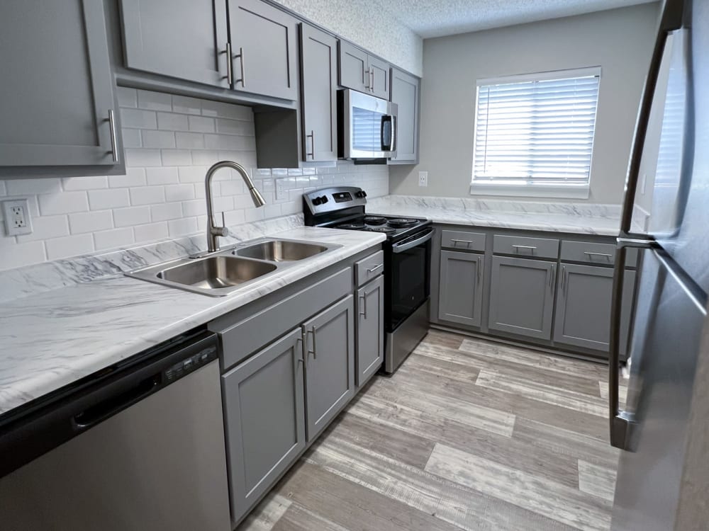 Cabinets and plenty of counter space in an apartment kitchen at Pinewood Station in Hillsborough, North Carolina