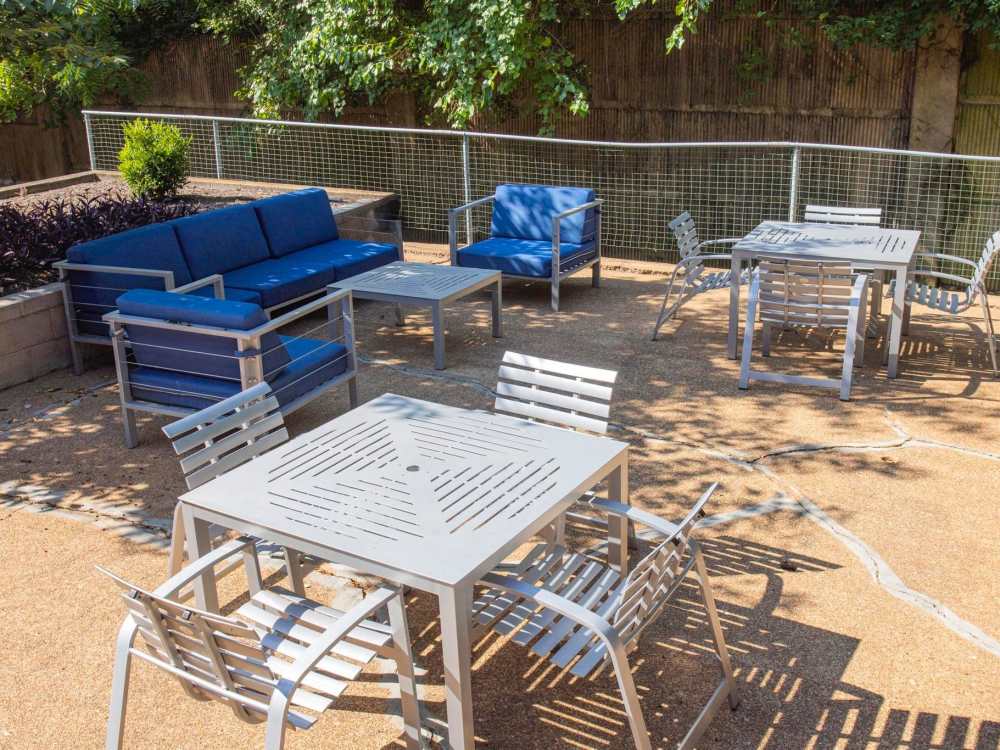 Outdoor Lounge Area with Grill and Corn Hole