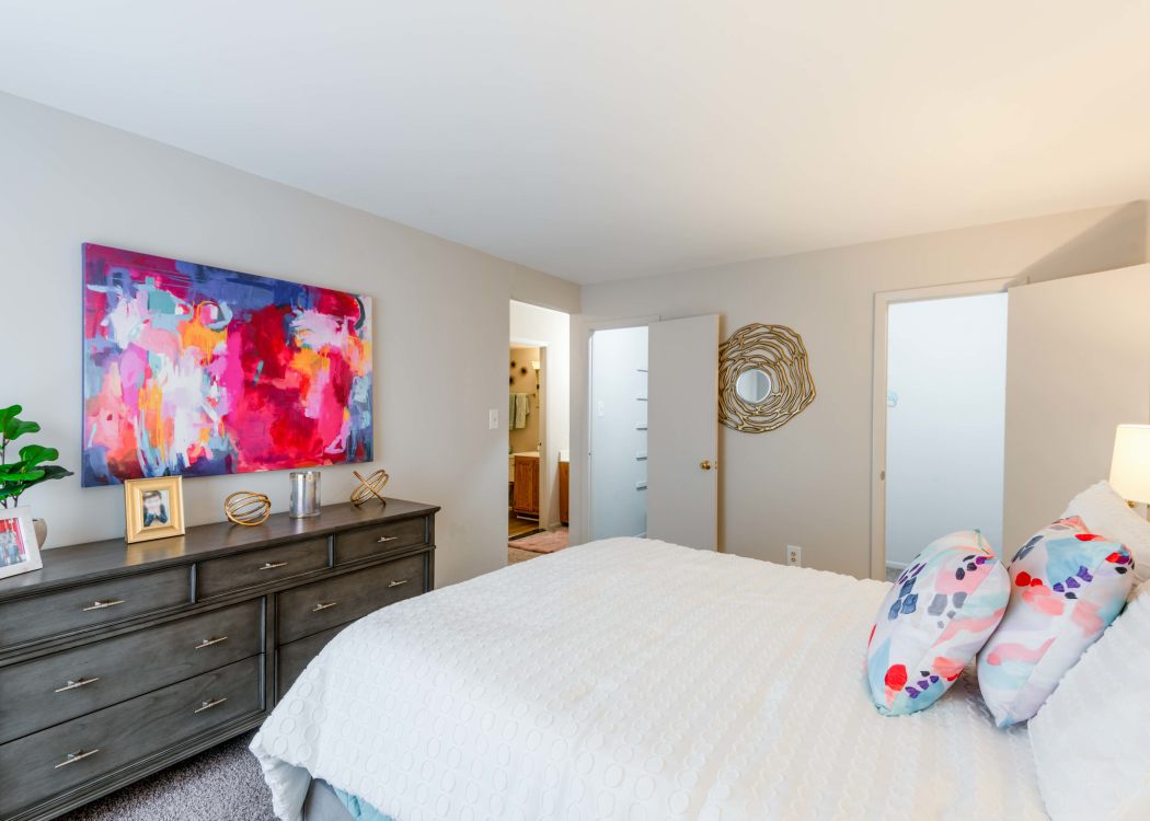 Large bedroom in a model home at The Timbers at Long Reach Apartments in Columbia, Maryland