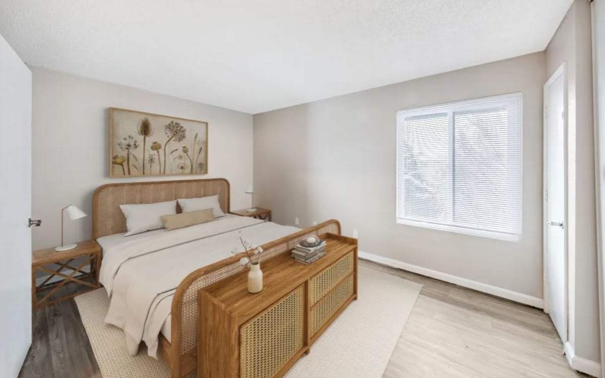 Pleasing bedroom with large bed, large window with blinds and cabinetry at Kirman Garden in Reno, Nevada