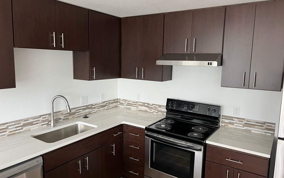 Modern kitchen with white countertops and black range at Pine View in La Pine, Oregon