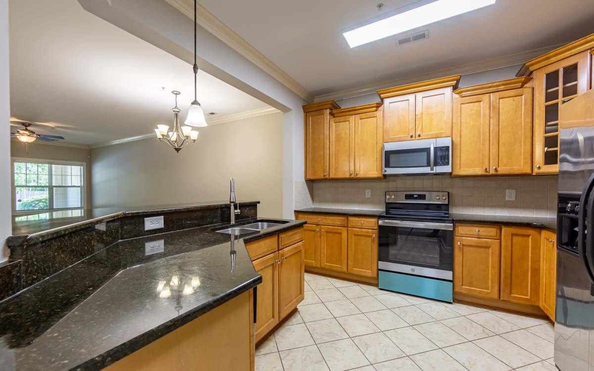 Kitchen with raised counter bar at Amelia Apartments in Fayetteville, North Carolina