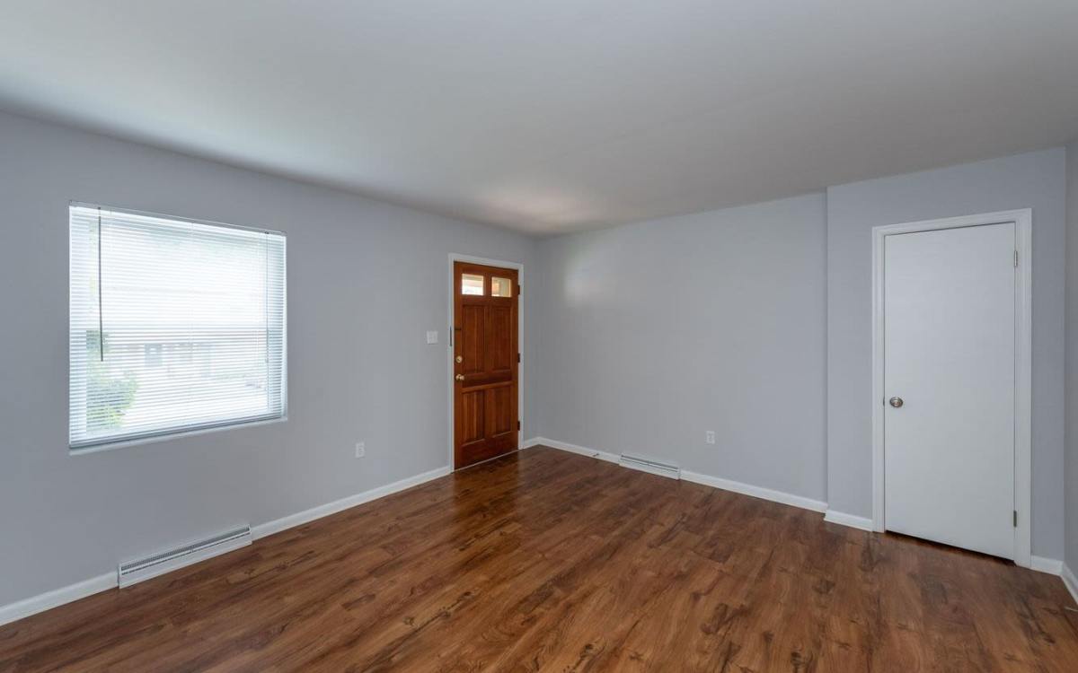 Bedroom with wood-style flooring at Signal Point Apartments in Mechanicsville, Virginia