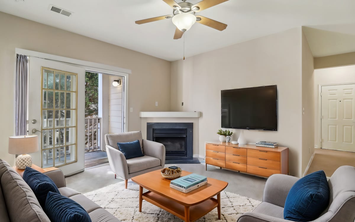 Living room with fireplace at Malvern Lakes Apartments in Fredericksburg, Virginia