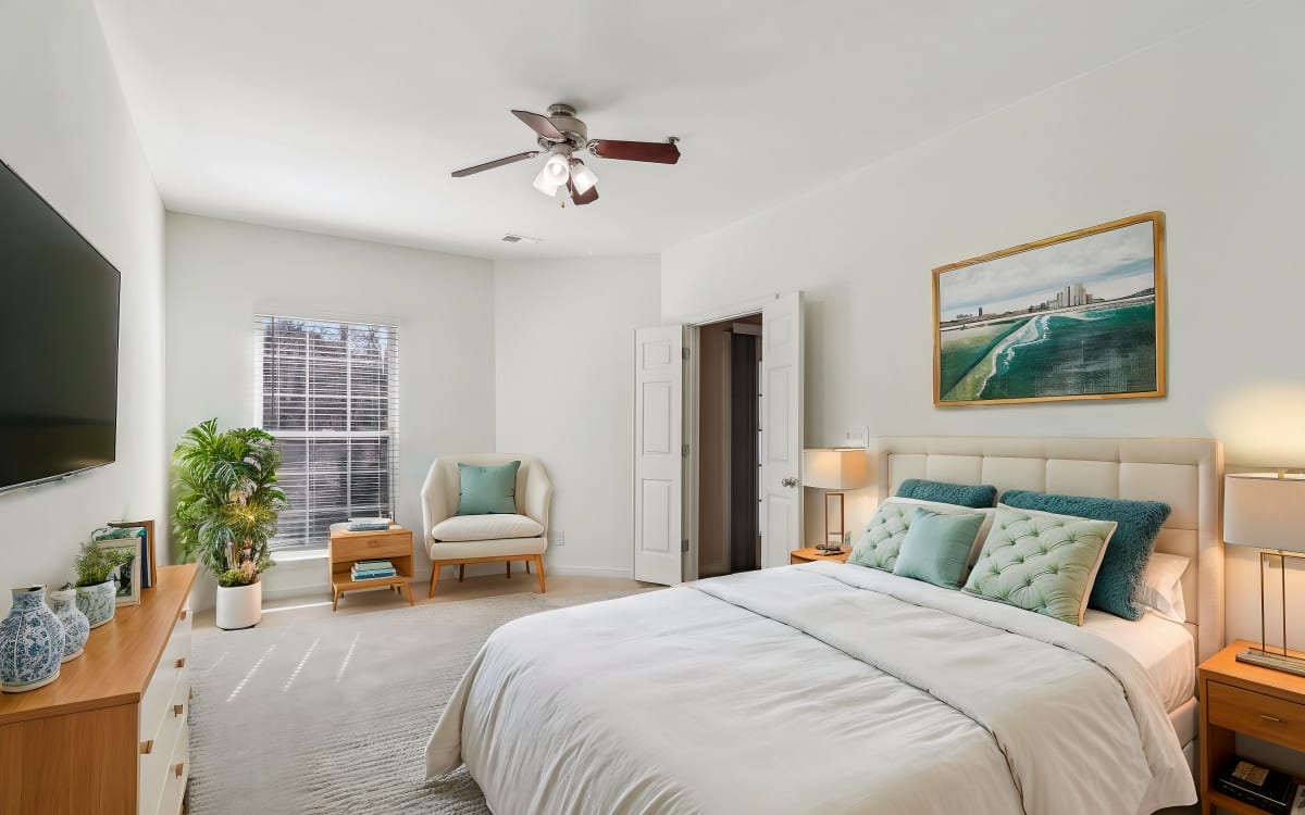 Model bedroom with wall art at Malvern Lakes Apartments in Fredericksburg, Virginia