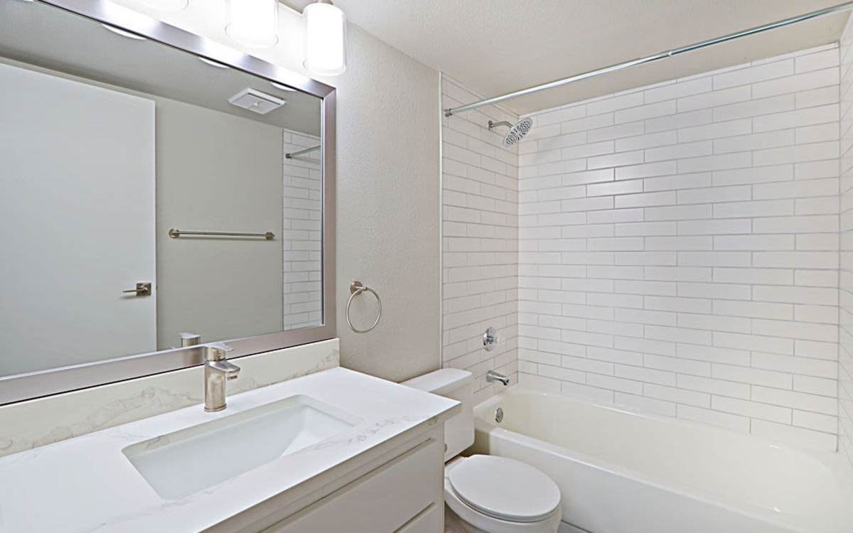 Bright bathroom with commode and bathtub at Strada in Tempe, Arizona