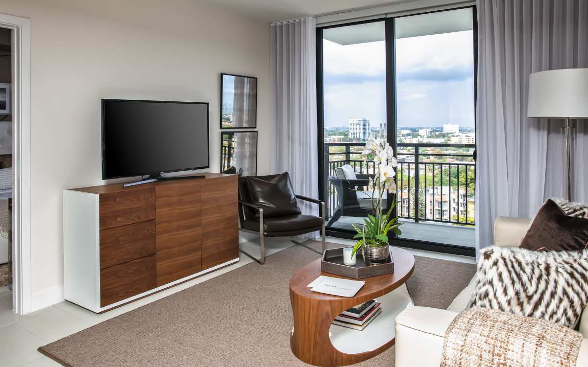 Spacious living room with balcony access at InTown Apartments in Miami, Florida