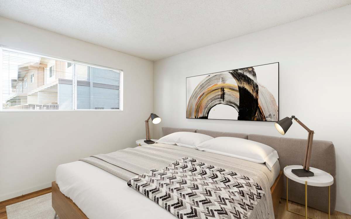 Bedroom with large comfortable bed at Sundale Apartments in Fremont, California