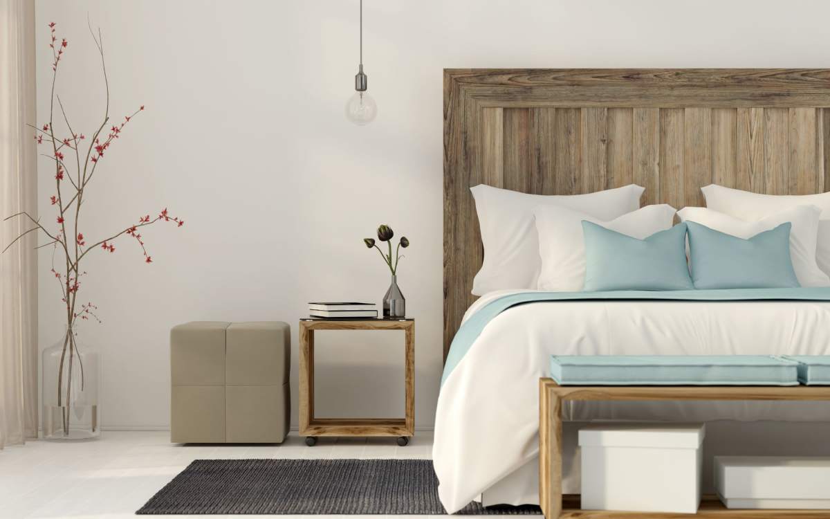 Bedroom with side table at Clintonville Commons in North Haven, Connecticut