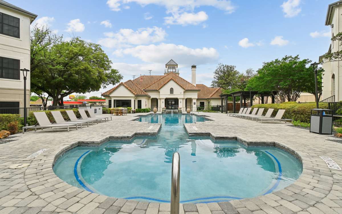 Resort-style pool with loungers at Benton in Dallas, Texas 