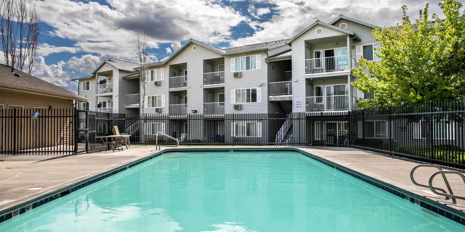 Pool area in front of the apartments at Heron Creek Apartments apartments in Moses Lake, Washington