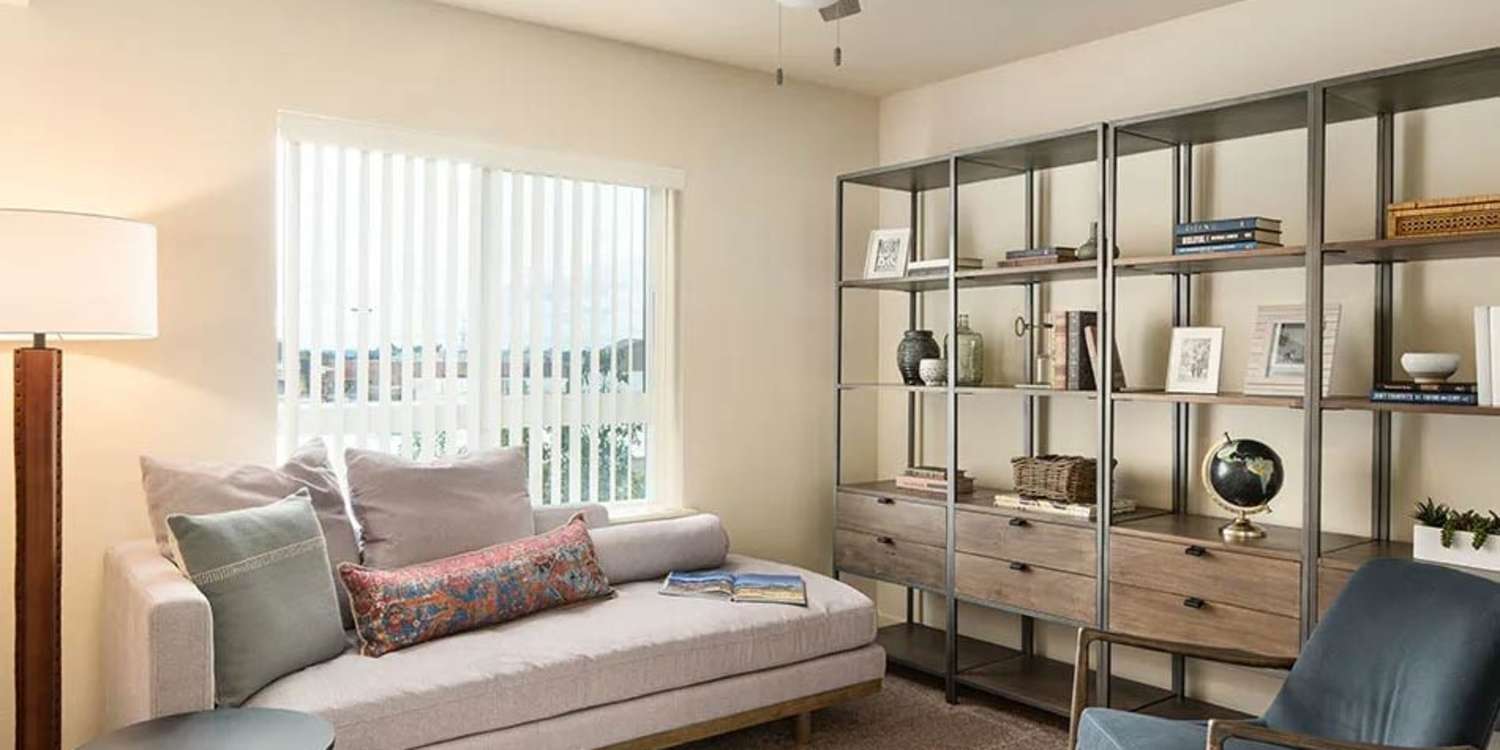 Spacious living room with couch, chairs, and hard-wood style flooring at Traditions at Federal Way in Federal Way, Washington