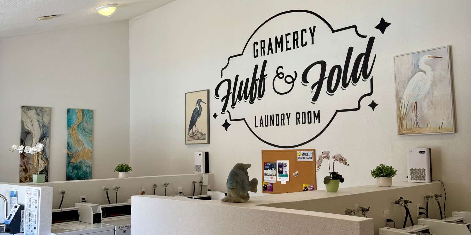 Happy couple holding grocery bags at Gramercy Apartments in San Diego, California