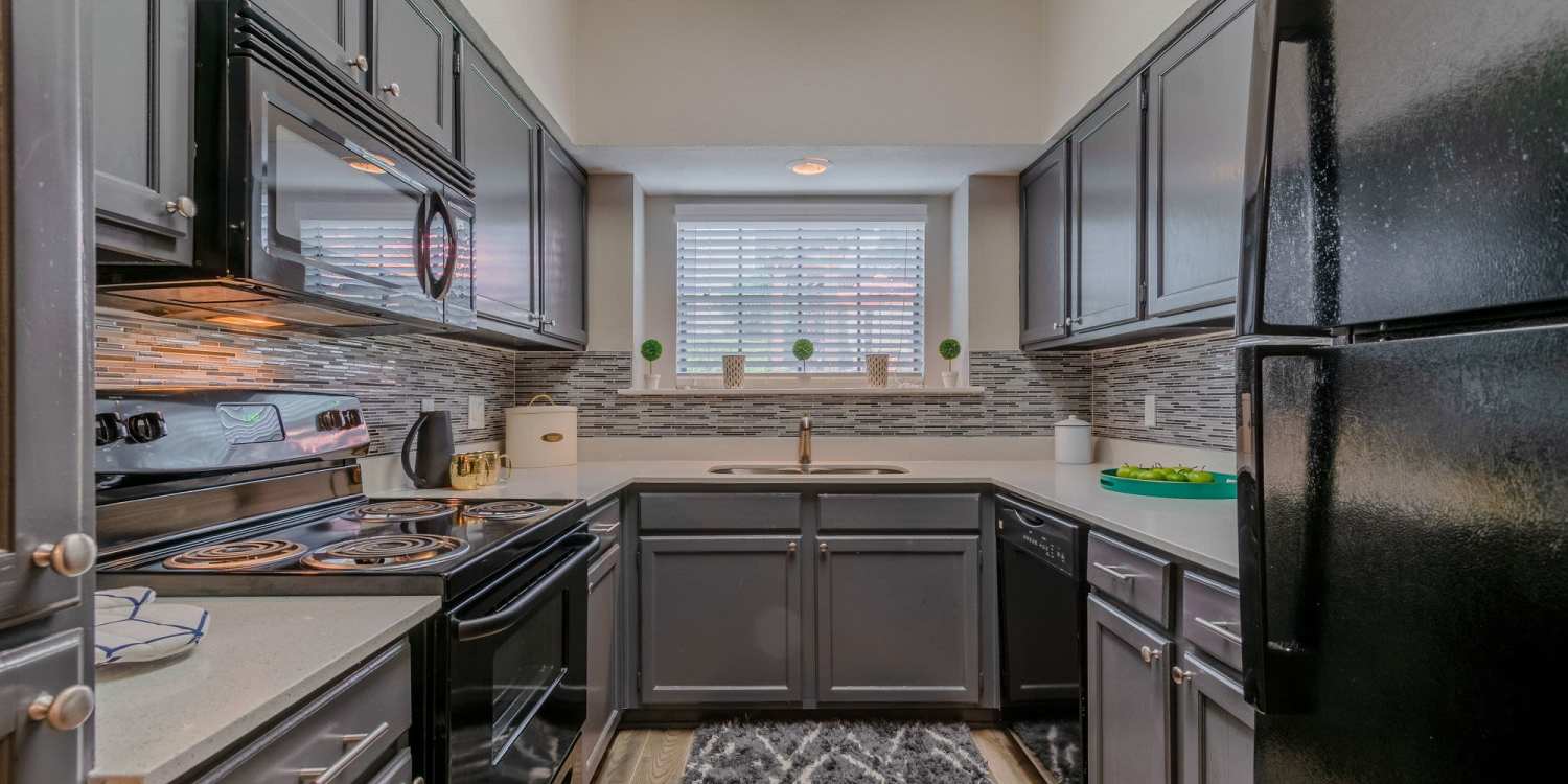 Kitchen with black appliances at The Vineyards at Trophy Club in Trophy Club, Texas