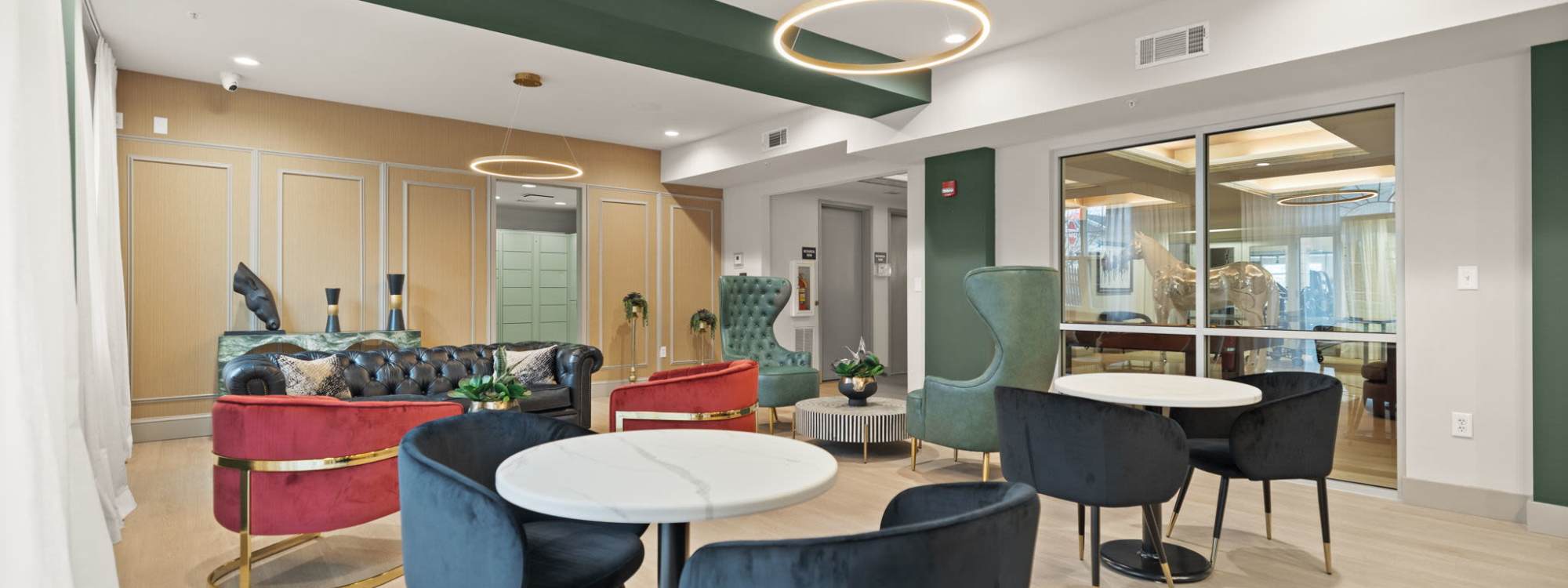 Community seating area with chairs and tables at The Wyatt in Lexington, Kentucky