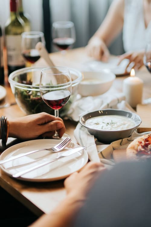 Residents having a delicious dinner with some friends at Madrona Apartments in Washington, District of Columbia