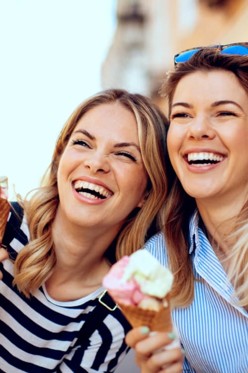 Best friends enjoying ice cream together near The Cromwell in Washington, District of Columbia