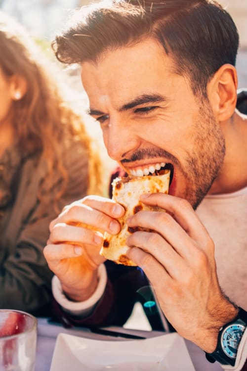 Man eating a tasty sandwich from a local deli near Hawaiian Gardens in Washington, District of Columbia