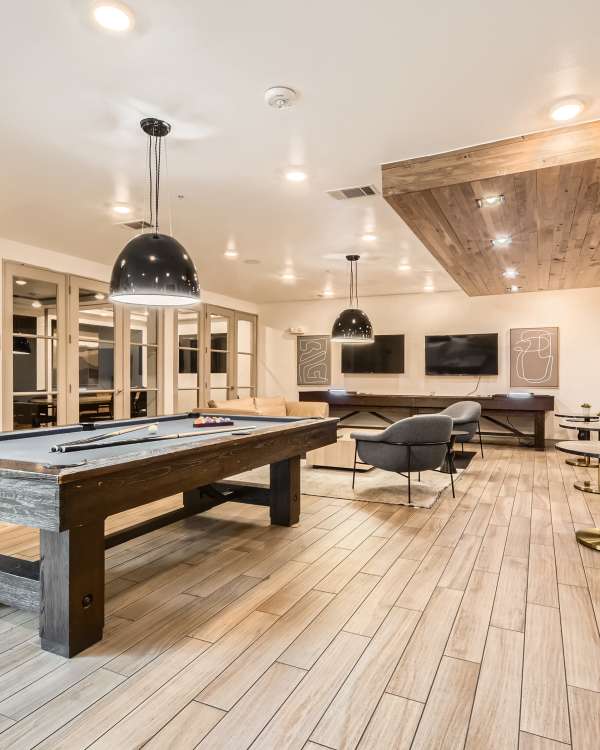 Fitness center featuring modern exercise equipment and free weights at Factory Design District in Dallas, Texas