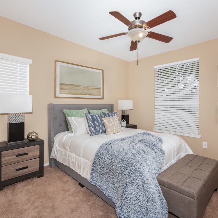 Model bedroom with a ceiling fan at Lakeview at Parkside