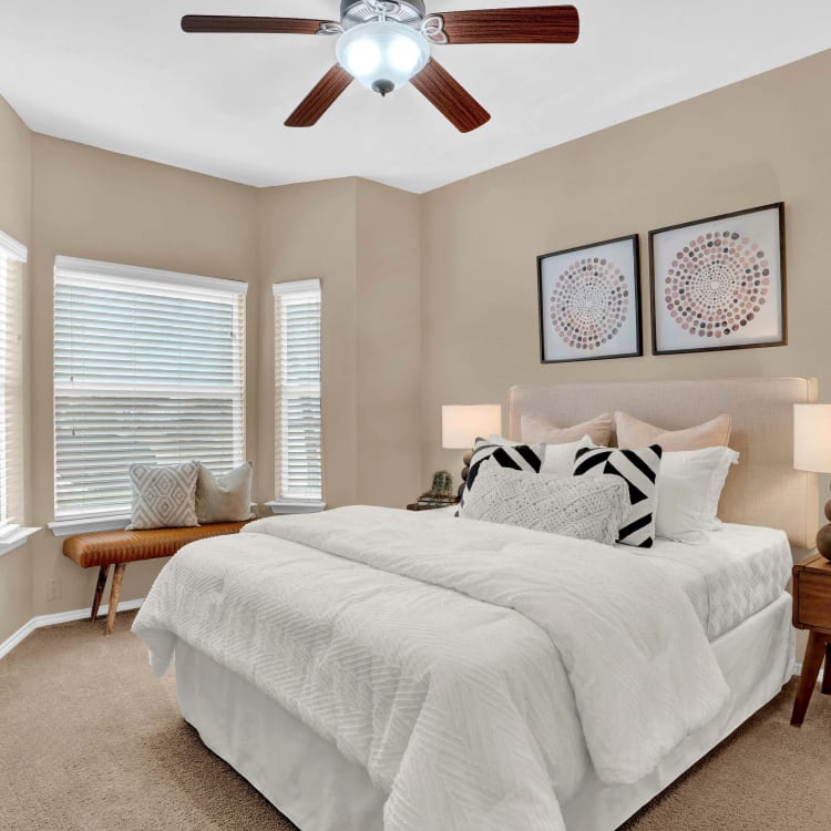 Bedroom with ceiling fan at Villas of Preston Creek in Plano, Texas