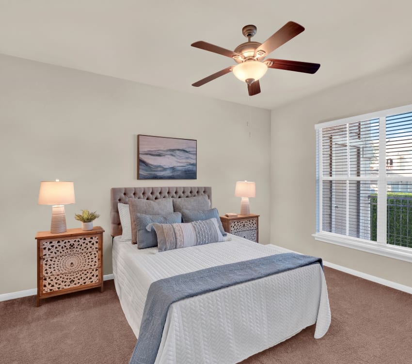 Bedroom with ceiling fan at Sedona Ranch Apartments