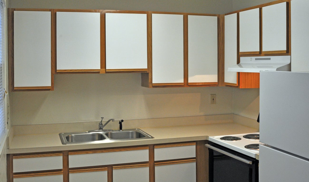 Kitchen with white cabinets at St. Johns Landing Apartments in Green Cove Springs, Florida