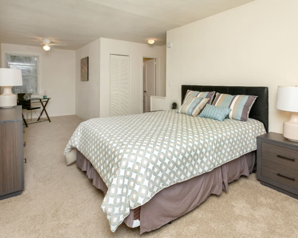 Apartment Bedroom With Bed And Desk at St. Johns Landing Apartments in Green Cove Springs, Florida