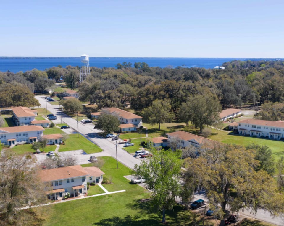 Aerial View Of Apartments With Water Tower In The Background at St. Johns Landing Apartments in Green Cove Springs, Florida