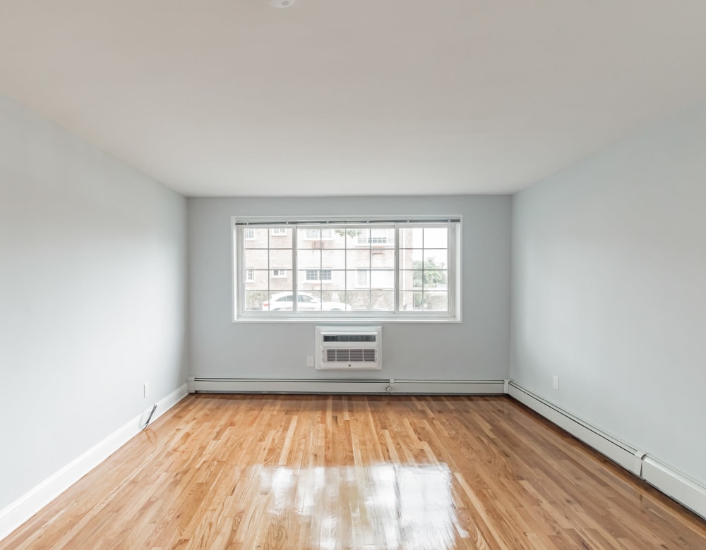 Hardwood flooring in a bright bedroom at Eagle Rock Apartments at Carle Place in Carle Place, New York
