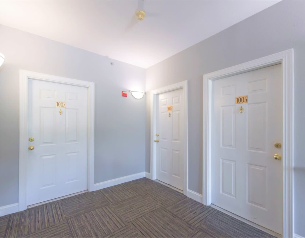 Hallway with entry doors to resident homes at Eagle Rock Apartments at Fishkill in Fishkill, New York