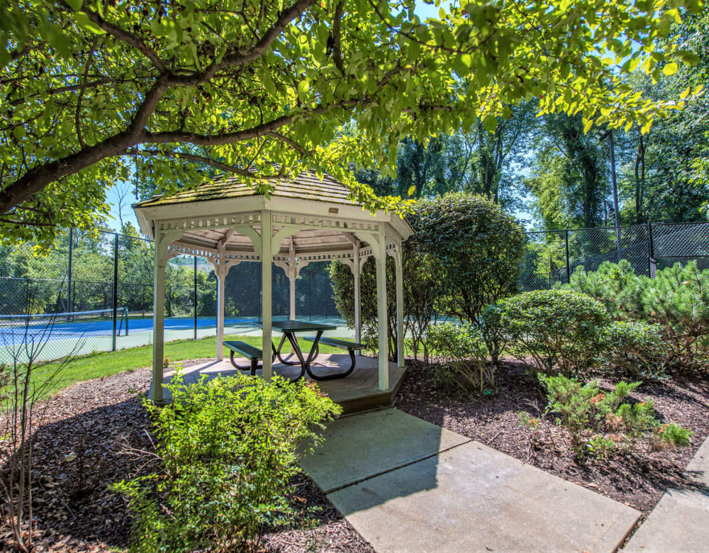 Courtyard and gazebo surrounded by mature trees at Eagle Rock Apartments at Fishkill in Fishkill, New York