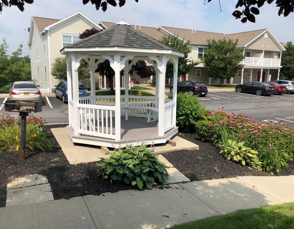 Gazebo surrounded by flourishing flora at Eagle Rock Apartments & Townhomes at Rensselaer in Rensselaer, New York