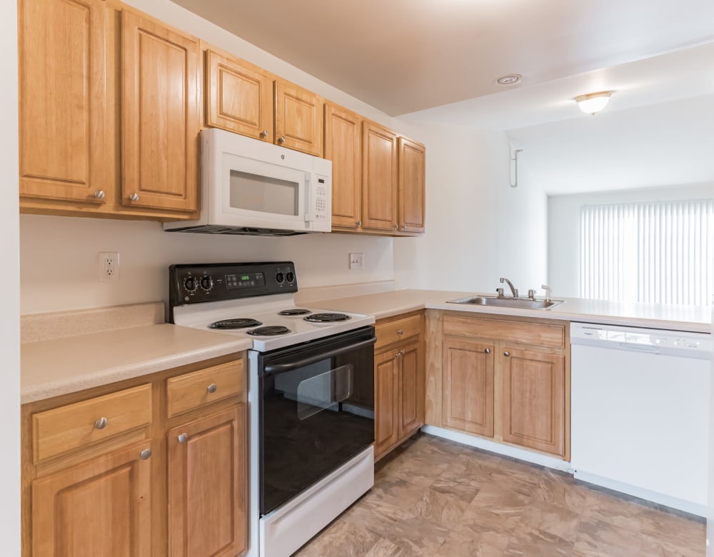 White appliances in a model home's kitchen at Eagle Rock Apartments & Townhomes at Rensselaer in Rensselaer, New York