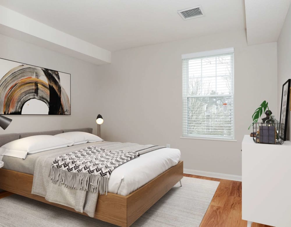 Bedroom with wood style flooring at Bay Ridge at Nashua Apartments in Nashua, New Hampshire