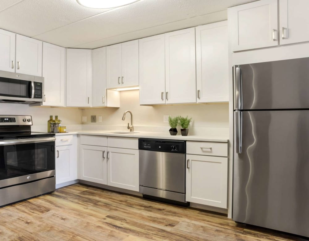 Open kitchen with hardwood flooring at Bay Ridge at Nashua Apartments in Nashua, New Hampshire