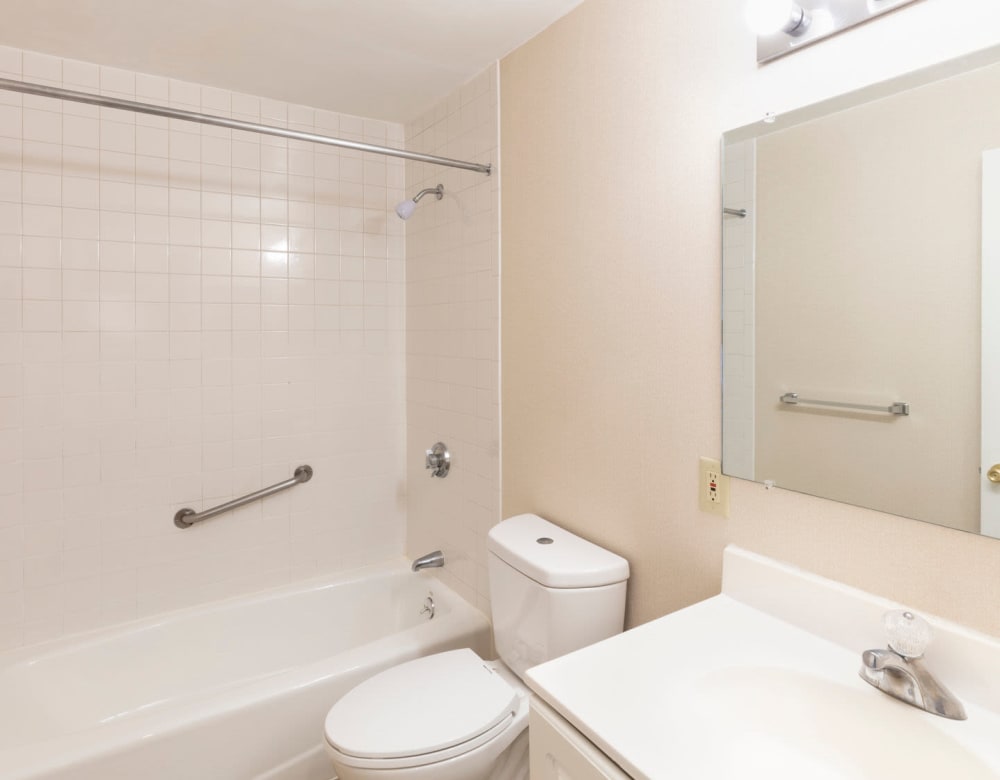 Bathroom with all white features at Eagle Rock Apartments at Framingham in Framingham, Massachusetts