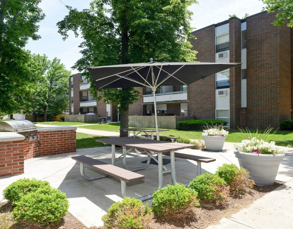 Picnic table with umbrella at Eagle Rock Apartments & Townhomes at Brighton in Brighton, Massachusetts