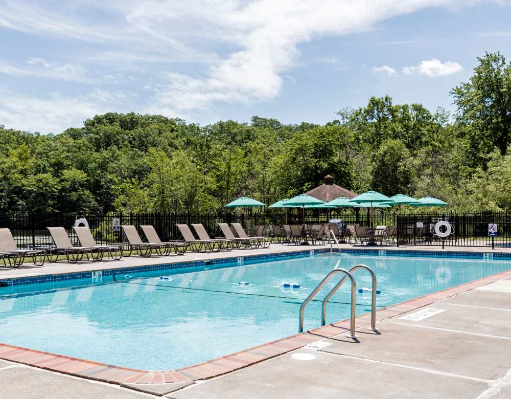 Pool area with set of deck chairs at Eagle Rock Apartments at Mohegan Lake in Mohegan Lake, New York