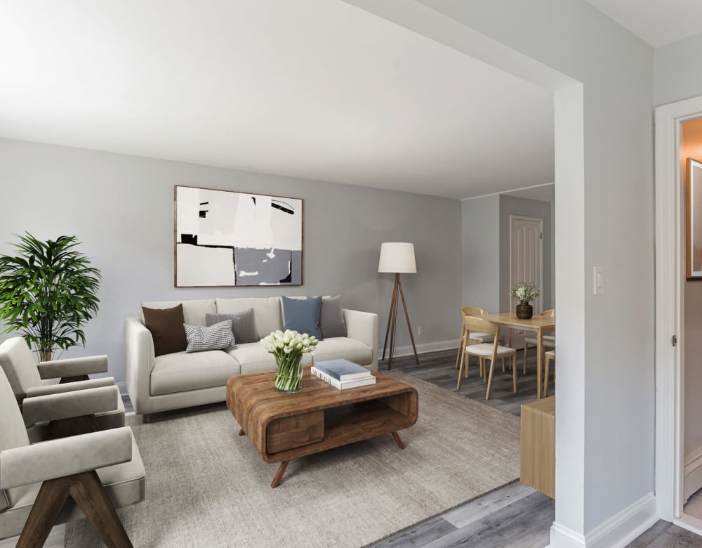 Living room with a plant accent at Mid Island Apartments Bay Shore, New York