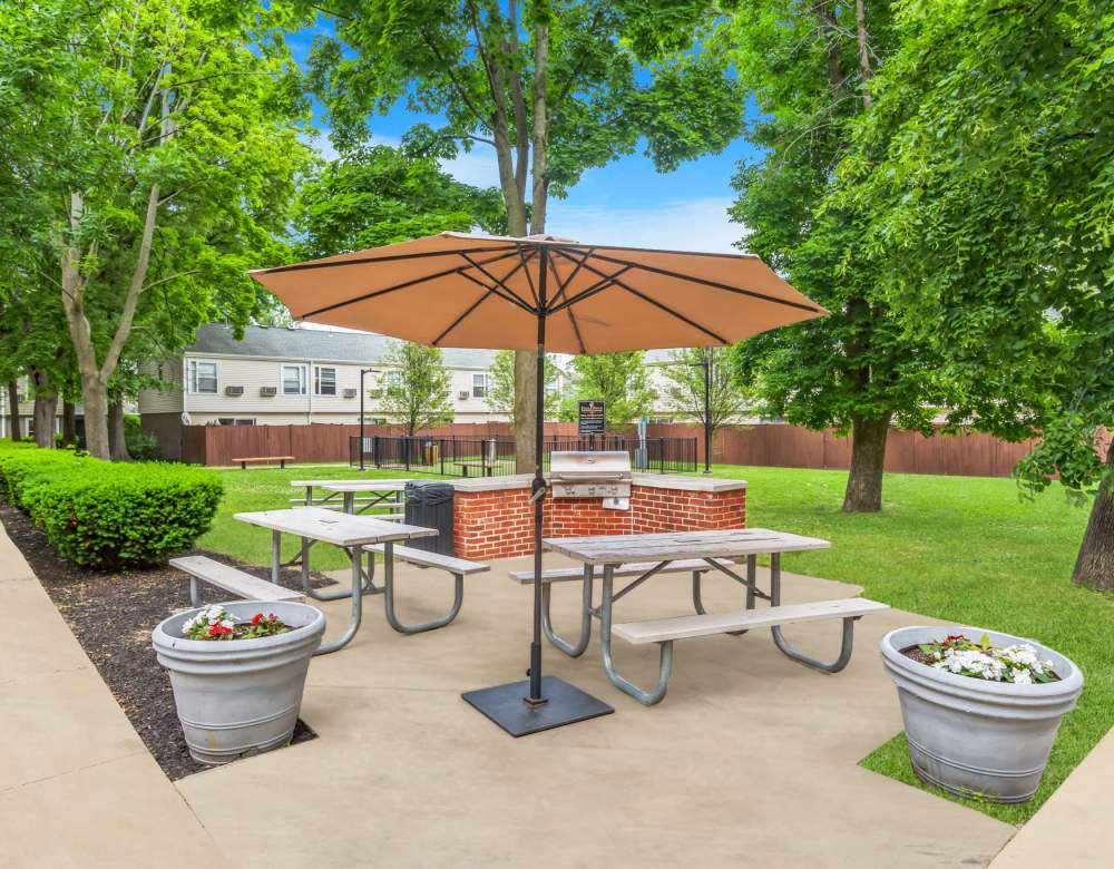  Umbrella and picnic tables at Eagle Rock Apartments & Townhomes at Brighton in Brighton, Massachusetts