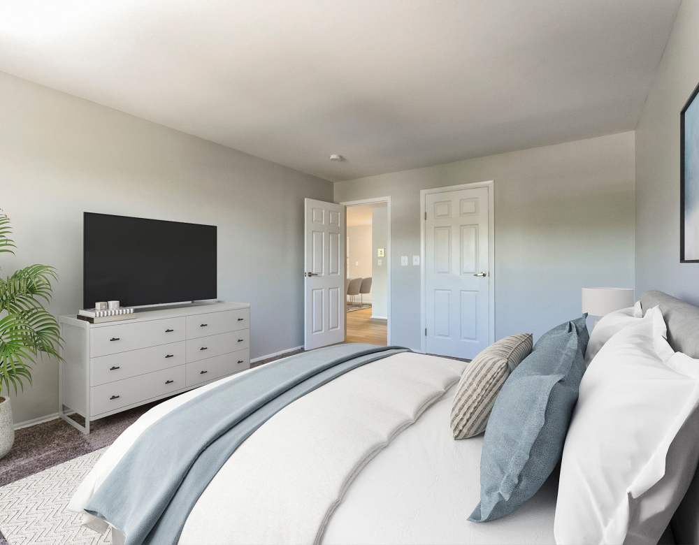 Blue and white Duvet bedroom at Eagle Rock Apartments at Framingham memory care in Framingham, Massachusetts