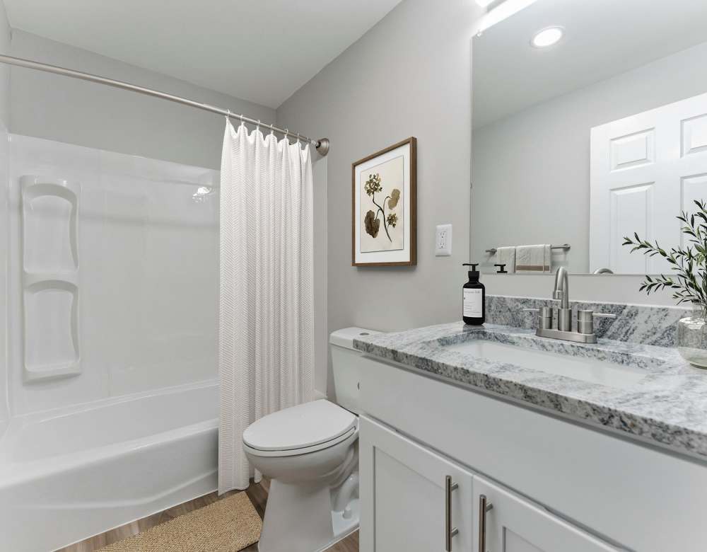 Pristine white bathroom at Eagle Rock Apartments at Framingham memory care in Framingham, Massachusetts