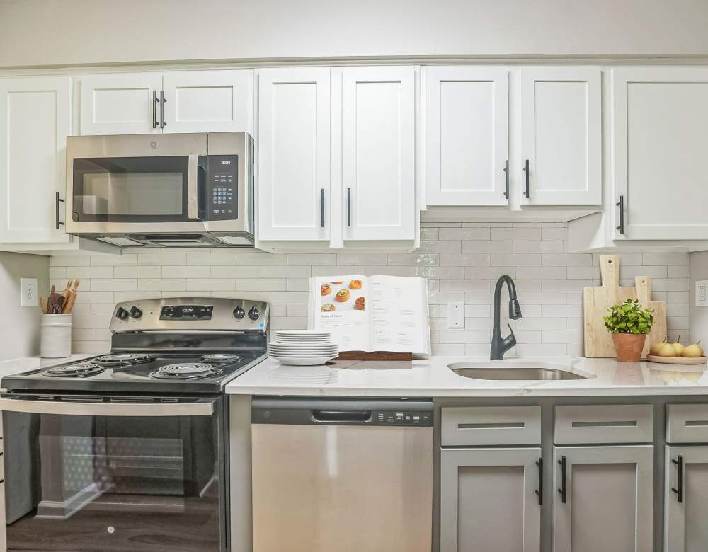 Modern kitchen with white cabinets at Ramblewood Village Apartments in Mount Laurel, New Jersey