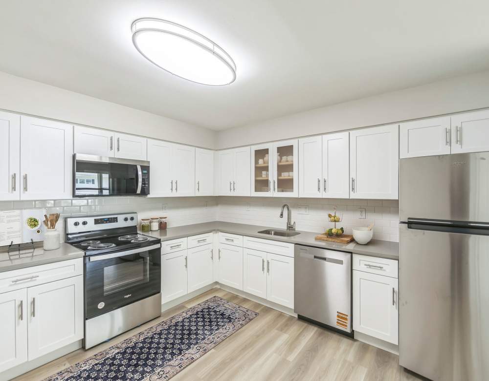 Modern kitchen with white shaker cabinets at Northway Eleven, An Eagle Rock Community in Ballston Lake, New York