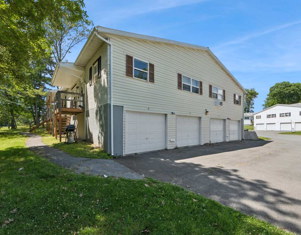 Exterior of apartment home with garages at Northway Eleven, An Eagle Rock Community in Ballston Lake, New York