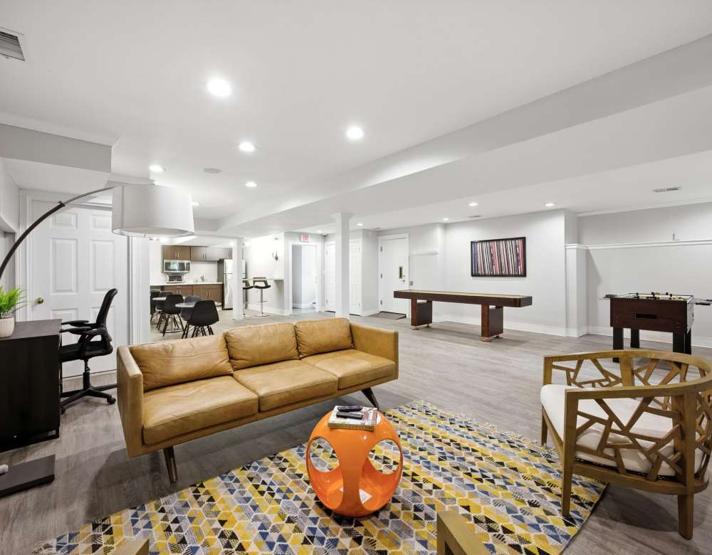 Modern recreation room with billiards table and seating area at  Summit at Mill Ridge