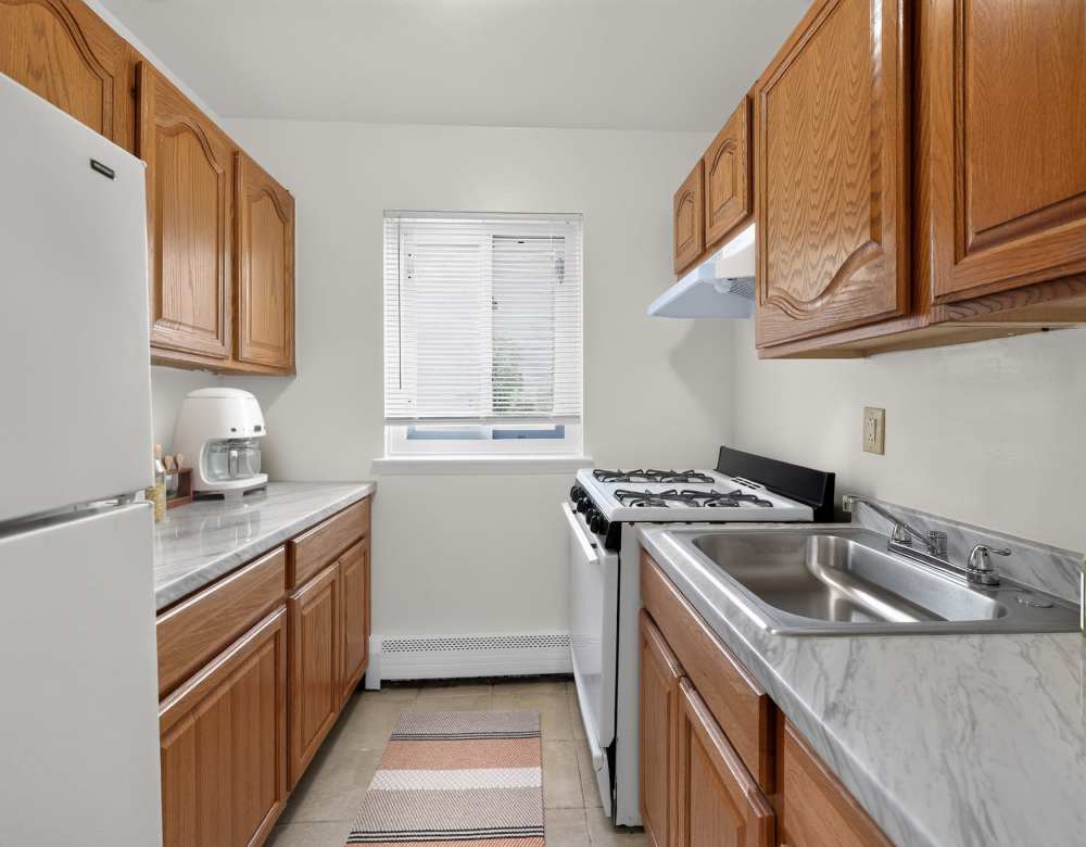 Modern kitchen with energy-efficient appliances at Eagle Rock Apartments at Patchogue Preserve in East Patchogue, New York
