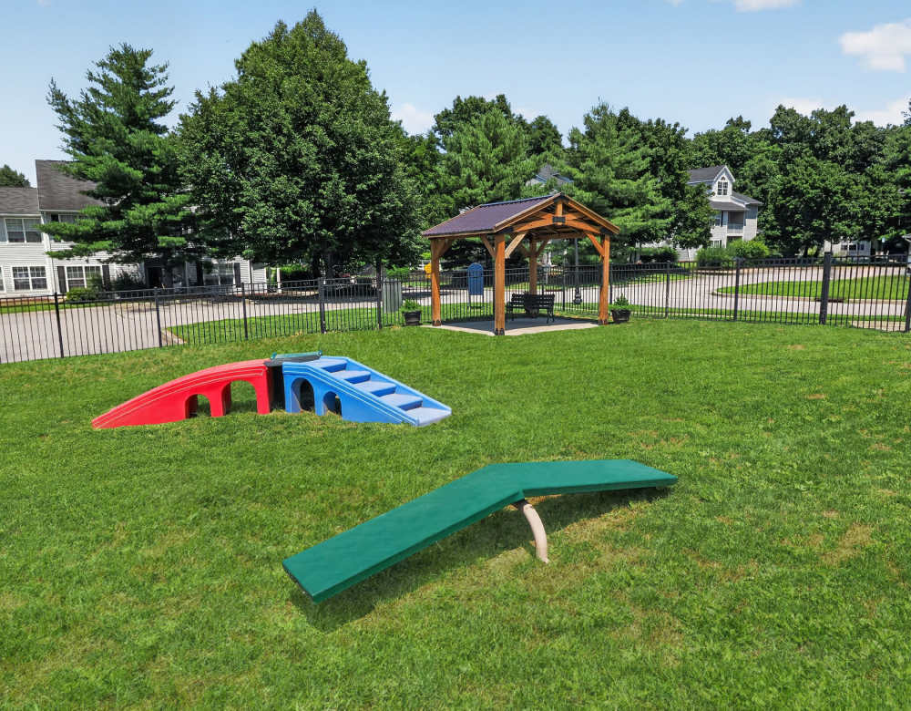 Covered pavilion with picnic tables overlooking grassy lawn at Vista Point Apartments in Wappingers Falls, New York